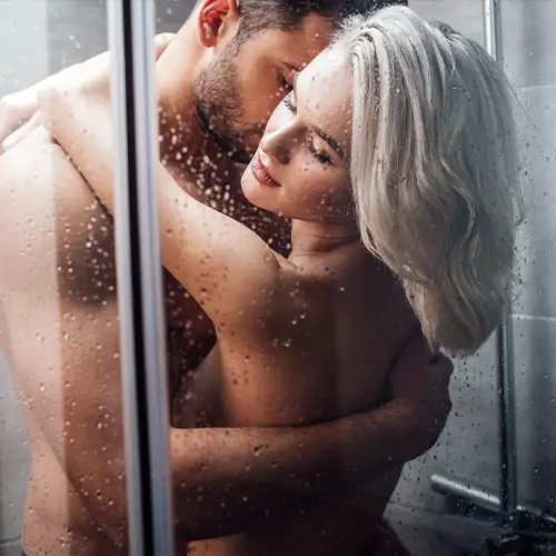 Couple embracing in the shower, symbolising intimacy and pre-blow job prep