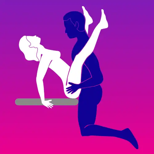 Edge Tease sex position – partner sitting on the edge while other stands for intimate angle